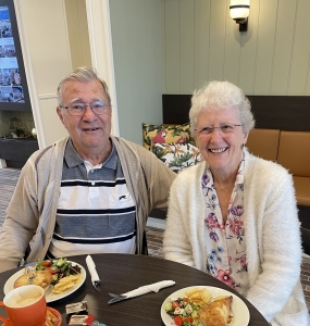 Two residents enjoying a pie and coffee at the Samford Grove cafe.