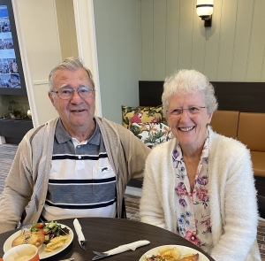 Two residents enjoying a pie and coffee at the Samford Grove cafe.
