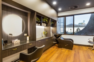 Samford Grove's hair and beauty salon with wooden floor boards and a dark, modern theme.